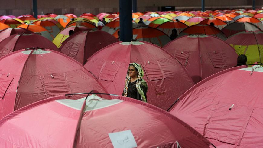 A woman is seen as people shelter at a stadium after a flooding in Golestan province, Iran, March 24, 2019. Picture taken March 24, 2019. Tasnim News Agency/via REUTERS ATTENTION EDITORS - THIS PICTURE WAS PROVIDED BY A THIRD PARTY - RC1E80C0C5F0