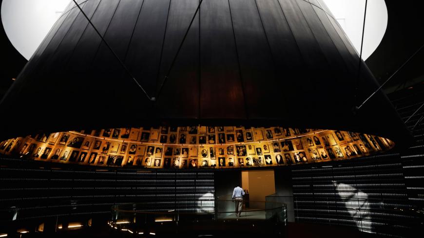 A security personnel walks at the Hall of Names at the Yad Vashem World Holocaust Remembrance Center in Jerusalem, before beginning of Israel's annual Holocaust Remembrance Day, as the centre is closed following the coronavirus disease (COVID-19) restrictions around the country, April 20, 2020 REUTERS/ Ronen Zvulun - RC2E8G9J1PCO