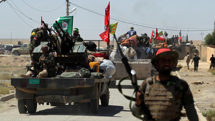 Members of the Iraqi pro-government Hashed al-Shaabi (Popular Mobilisation) paramilitary forces gather in a street in the modern town of Hatra, near the eponymous UNESCO-listed ancient city, southwest of the northern city of Mosul, on April 28, 2017.
Iraqi forces retook the town of Hatra, southwest of Mosul, on the third day of an operation that saw them wrest back the archeological site from the Islamic State group. The ancient city is one of the heritage jewels of Iraq and was damaged by IS after they too