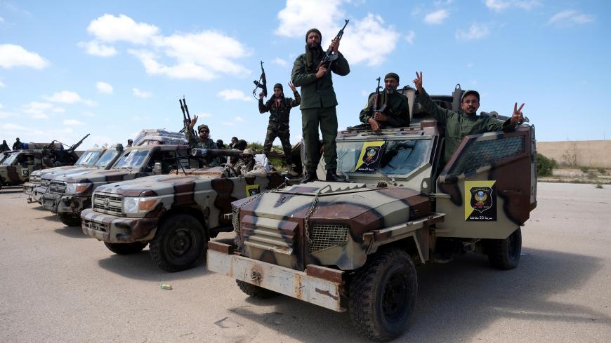 Libyan National Army (LNA) members, commanded by Khalifa Haftar, pose for a picture as they head out of Benghazi to reinforce the troops advancing to Tripoli, in Benghazi, Libya April 7, 2019. REUTERS/Esam Omran Al-Fetori - RC14EB305380