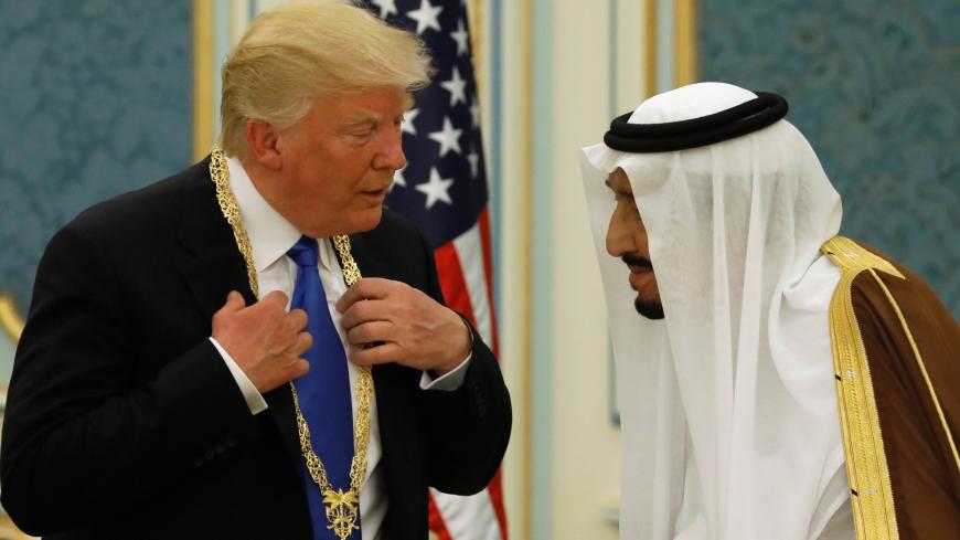 Saudi Arabia's King Salman bin Abdulaziz Al Saud (R) presents U.S. President Donald Trump with the Collar of Abdulaziz Al Saud Medal at the Royal Court in Riyadh, Saudi Arabia May 20, 2017. REUTERS/Jonathan Ernst TPX IMAGES OF THE DAY - RC18E76205A0