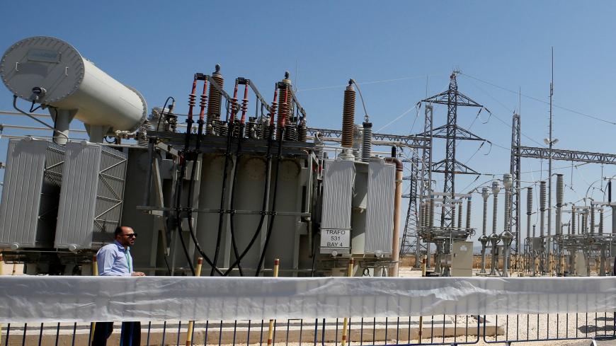 A worker walks in the new electrical substation near the West Bank city of Jenin July 10, 2017. REUTERS/Abed Omar Qusini - RC1E2622DFF0