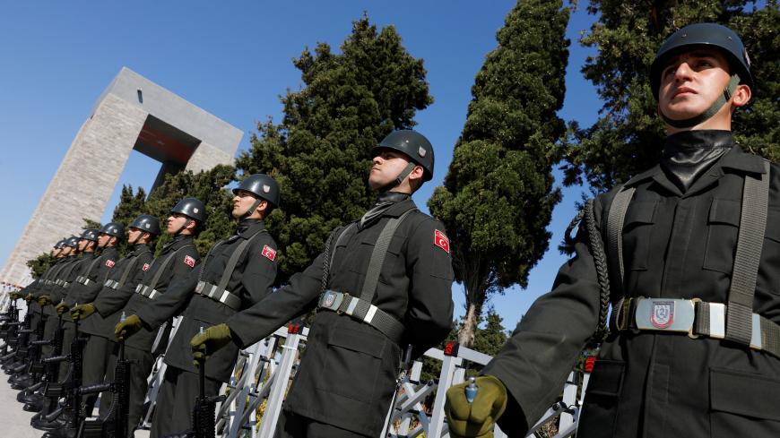 Turkish soldiers stand in front of the Turkish memorial during an international service marking the 103rd anniversary of the World War I campaign in Gallipoli, Turkey,  April 24, 2018. REUTERS/Umit Bektas - RC1E56201C10