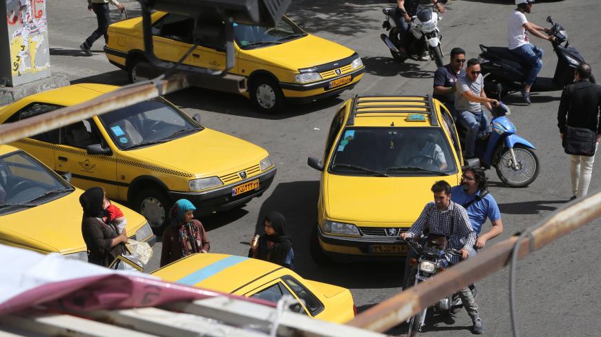 Iranians navigate the traffic in the capital Tehran on the eve of the presidential elections on May 18, 2017. / AFP PHOTO / ATTA KENARE (Photo credit should read ATTA KENARE/AFP/Getty Images)
