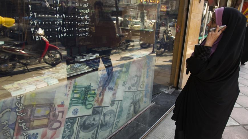 EDITORS' NOTE: Reuters and other foreign media are subject to Iranian restrictions on leaving the office to report, film or take pictures in Tehran.

A woman looks at exchange rates by the window of a currency exchange shop in Tehran's business district January 7, 2012. REUTERS/Raheb Homavandi  (IRAN - Tags: BUSINESS) - GM1E8171GYK01