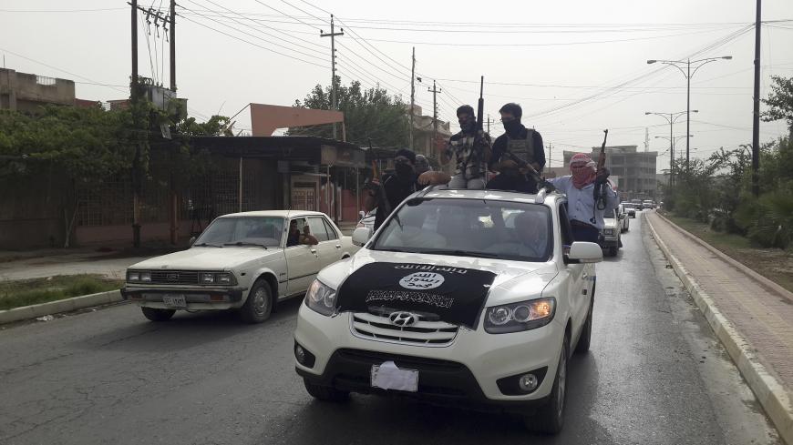Fighters of the Islamic State of Iraq and the Levant (ISIL) celebrate on vehicles taken from Iraqi security forces, at a street in city of Mosul, June 12, 2014. Since Tuesday, black clad ISIL fighters have seized Iraq's second biggest city Mosul and Tikrit, home town of former dictator Saddam Hussein, as well as other towns and cities north of Baghdad. They continued their lightning advance on Thursday, moving into towns just an hour's drive from the capital. Picture taken June 12, 2014. REUTERS/Stringer (I