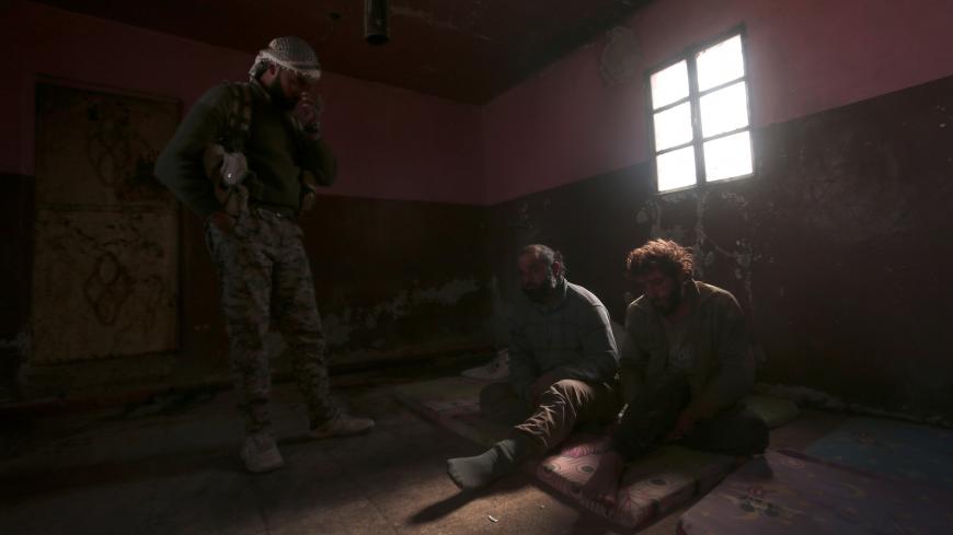 A Syrian Democratic Forces (SDF) fighter stands near who he said were Islamic State fighters held prisoners, north of Raqqa city, Syria March 8, 2017. REUTERS/Rodi Said      TPX IMAGES OF THE DAY - RC15149E3320