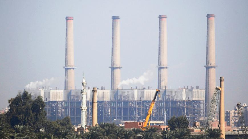 A South Cairo Electricity Distribution Company power station is seen in front of the construction site of a bridge, part of Rod El-Farag Axis project, near Cairo's Warraq Island, Egypt, November 15, 2018. REUTERS/Amr Abdallah Dalsh - RC15D612BA00