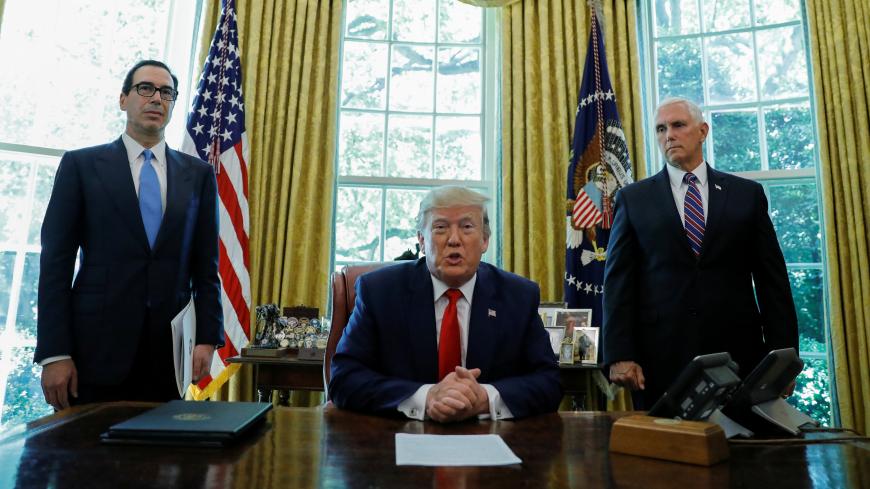 U.S.  President Donald Trump speaks before signing an executive order imposing fresh sanctions on Iran as Treasury Secretary Steven Mnuchin and Vice President Mike Pence look on in the Oval Office of the White House in Washington, U.S., June 24, 2019. REUTERS/Carlos Barria - RC1D3FDB52D0