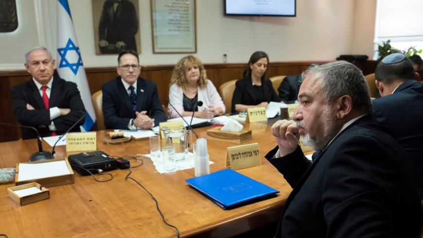 Israeli Defence Minister Avigdor Lieberman (R) sits opposite of Israeli Prime Minister Benjamin Netanyahu and Israeli Cabinet Secretary Tzachi Braverman during the weekly cabinet meeting at the prime minister's office in Jerusalem, June 10, 2018. Jim Hollander/Pool via Reuters - RC13DBD58690