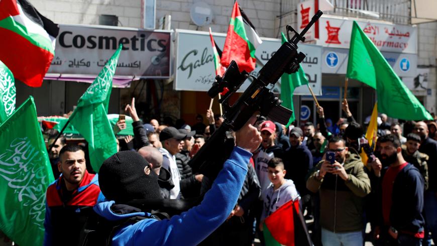A gunman holds a weapon during the funeral of Samah Mubarak, in Ramallah in the Israeli-occupied West Bank March 9, 2019. REUTERS/Mohamad Torokman - RC1FBCB4BD50