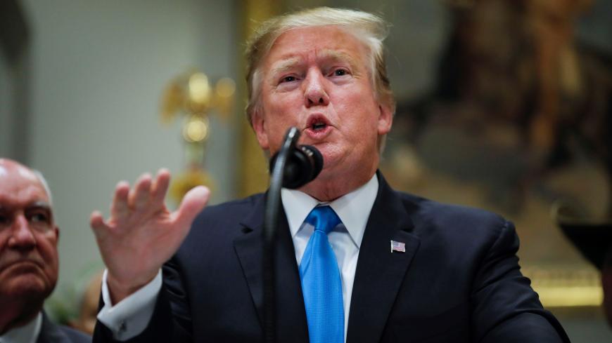 U.S. President Donald Trump speaks to reporters about a range of issues as Secretary of Agriculture Sonny Perdue looks on during an event devoted to "America's farmers and ranchers" in the Roosevelt Room of the White House in Washington, U.S., May 23, 2019. REUTERS/Carlos Barria - RC131BDDFC60