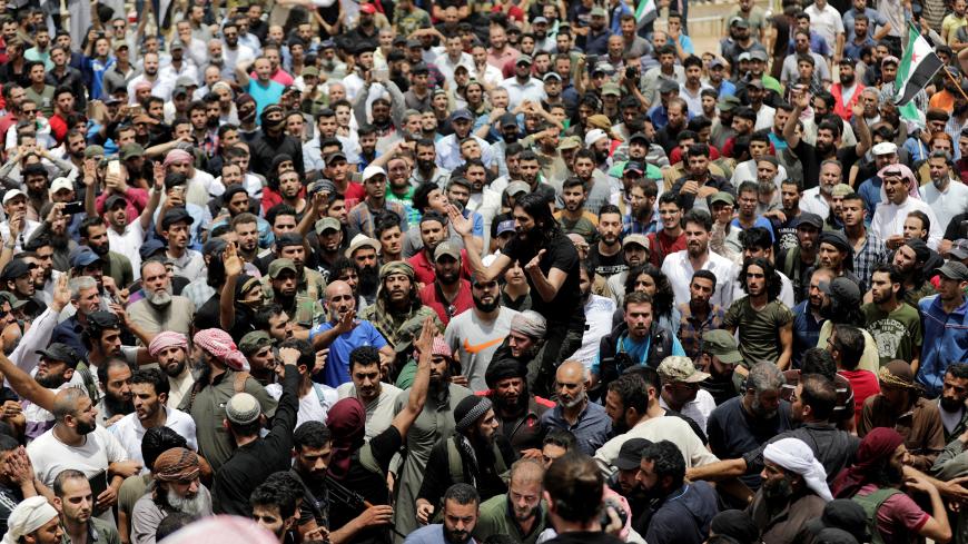 People gather during the funeral of Abdelbasset al-Sarout, 27, who died from wounds he sustained battling in northwest Syria, in the border town of al-Dana, Idlib, Syria June 9, 2019. REUTERS/Khalil Ashaw - RC16B44F3FF0
