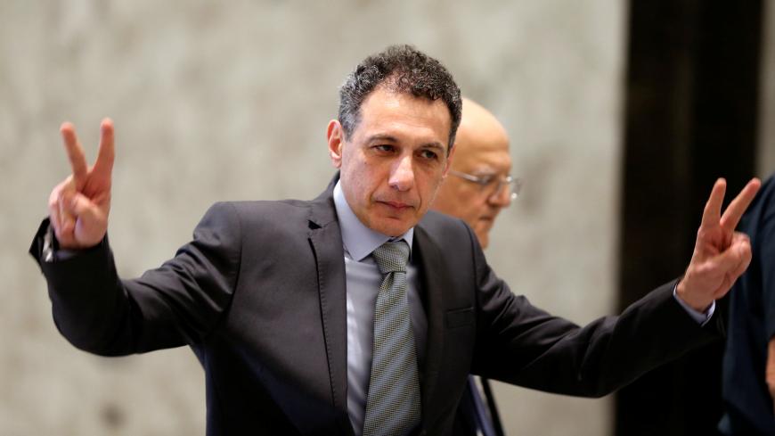 Freed Lebanese businessman Nizar Zakka, who had been detained in Iran since 2015, gestures as he arrives at the presidential palace in Baabda, Lebanon June 11, 2019. REUTERS/Mohamed Azakir - RC115C2D85E0