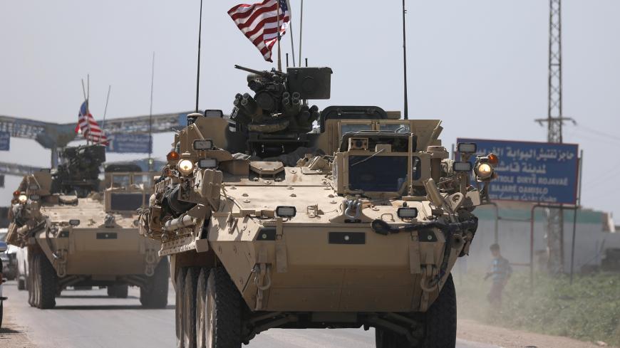 U.S military vehicles travel in the northeastern city of Qamishli, Syria April 29, 2017. Picture taken April 29, 2017. REUTERS/Rodi Said - RC1FC8E9DC90