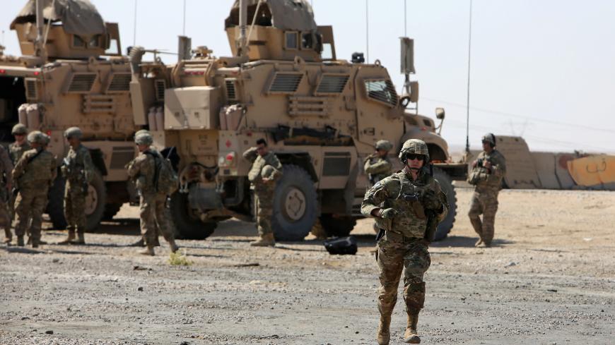 A U.S. soldier runs at a coalition forces forward base near West Mosul, Iraq June 21, 2017, where Iraqi security forces are fighting Islamic State.     REUTERS/Marius Bosch - RC1F464C5CA0