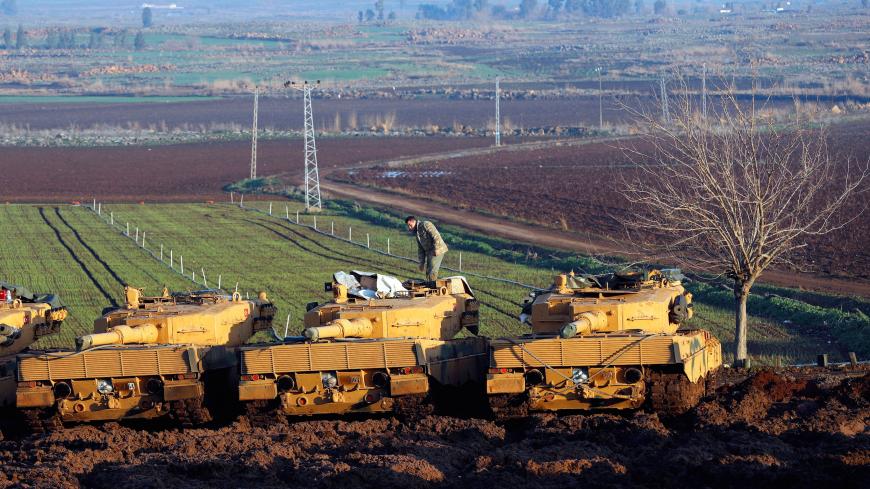 A Turkish soldier stands on top of a tank near the Turkish-Syrian border in Hatay province, Turkey, January 28, 2018. REUTERS/Murad Sezer - RC186578FC30