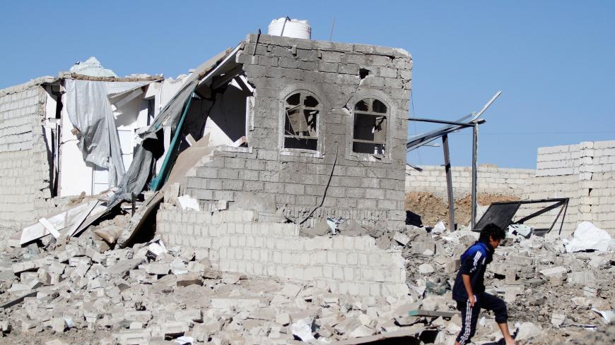 A boy is seen at the site of an airstrike launched by the Saudi-led coalition in Sanaa, Yemen, February 1, 2019. REUTERS/Mohamed al-Sayaghi - RC19CF75D3A0