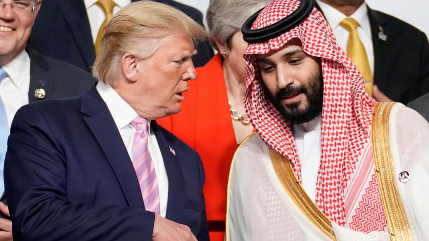 U.S. President Donald Trump speaks with Saudi Arabia's Crown Prince Mohammed bin Salman during family photo session with other leaders and attendees at the G20 leaders summit in Osaka, Japan, June 28, 2019. REUTERS/Kevin Lamarque - RC187E92FB00