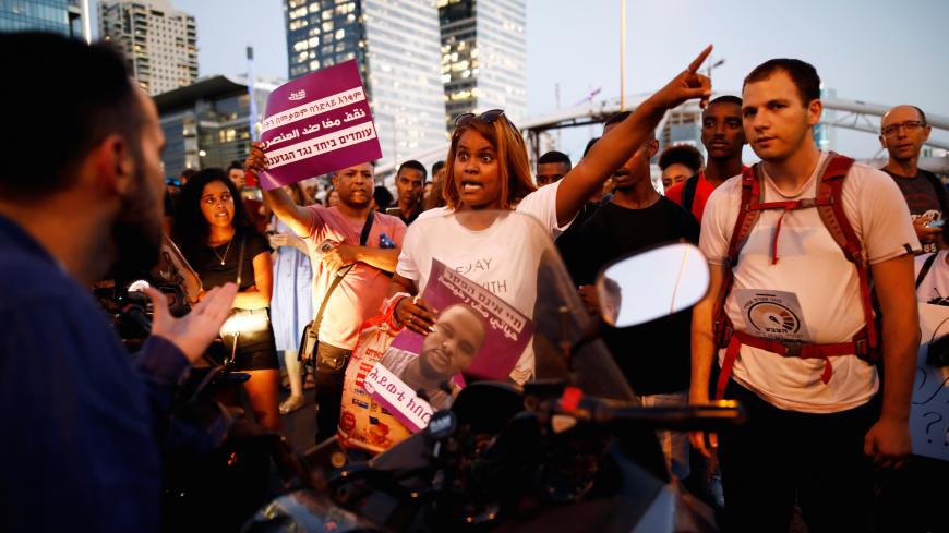 A protester argues with a rider as together with other protesters block a main road, during a protest for the death of 18-year old Solomon Tekah of Ethiopian descent, after he was shot by police, in Tel Aviv, Israel July 2, 2019. REUTERS/ Corinna Kern - RC1D27E1DFF0