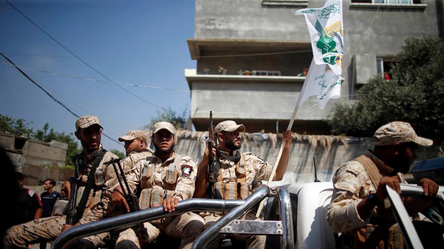 Palestinian Hamas militants take part in the funeral of their comrade Mahmoud Al-Adham, 28, in the northern Gaza Strip July 11, 2019. REUTERS/Mohammed Salem - RC12004A1310