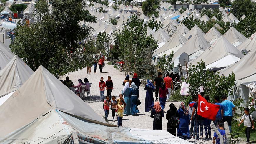 Syrian refugees stroll at a refugee camp in Osmaniye, Turkey, May 17, 2016. REUTERS/Umit Bektas                           - S1BETFDMXFAA