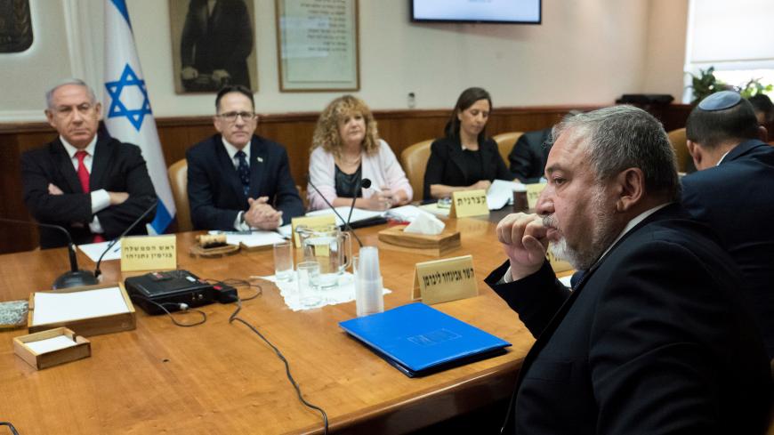 Israeli Defence Minister Avigdor Lieberman (R) sits opposite of Israeli Prime Minister Benjamin Netanyahu and Israeli Cabinet Secretary Tzachi Braverman during the weekly cabinet meeting at the prime minister's office in Jerusalem, June 10, 2018. Jim Hollander/Pool via Reuters - RC13DBD58690