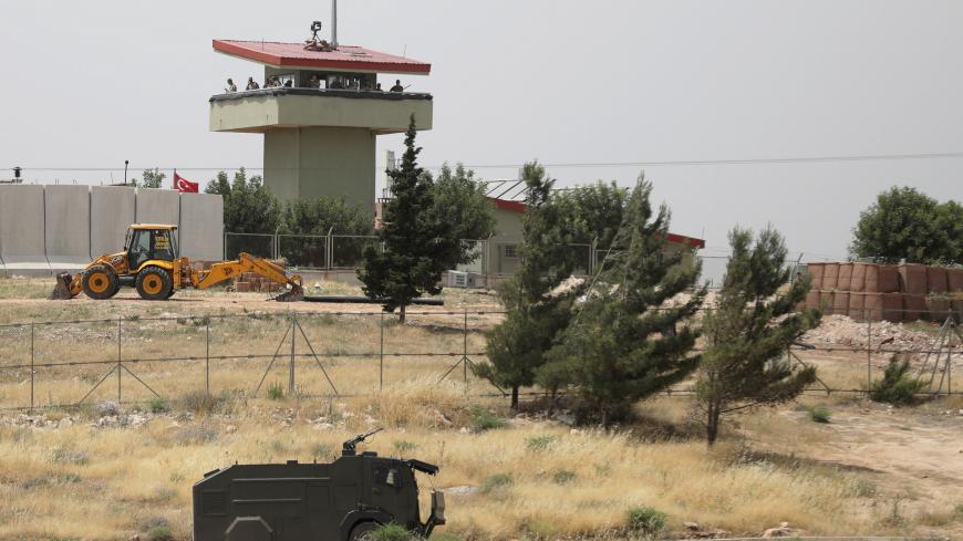 Turkish soldiers stand on a watch tower at the Atmeh crossing on the Syrian-Turkish border, as seen from the Syrian side, in Idlib governorate, Syria May 31, 2019. REUTERS/Khalil Ashawi - RC1525F30880