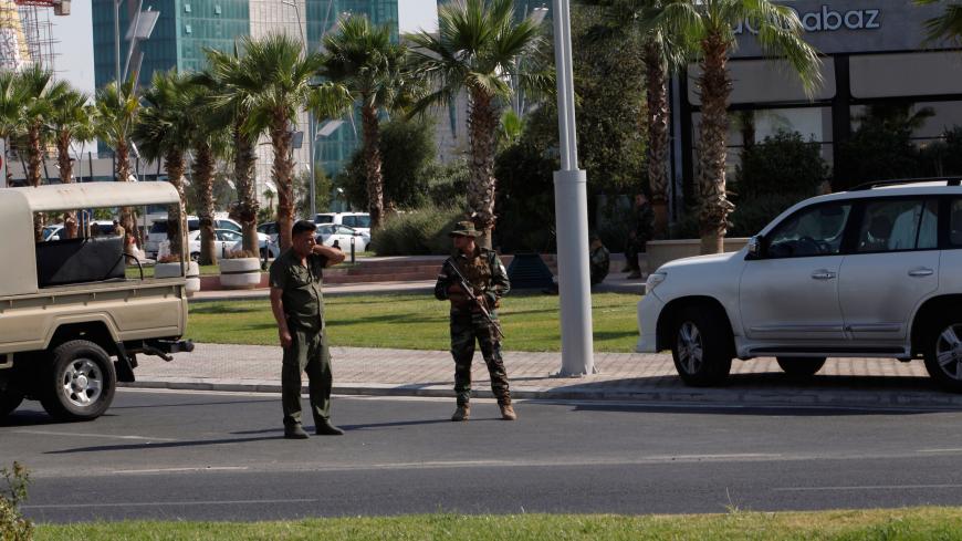 Kurdish security members stand guard near a restaurant where Turkish diplomats and Turkish consulate employee were killed in Erbil, Iraq July 17, 2019. REUTERS/Azad Lashkari - RC15FE0B8D60