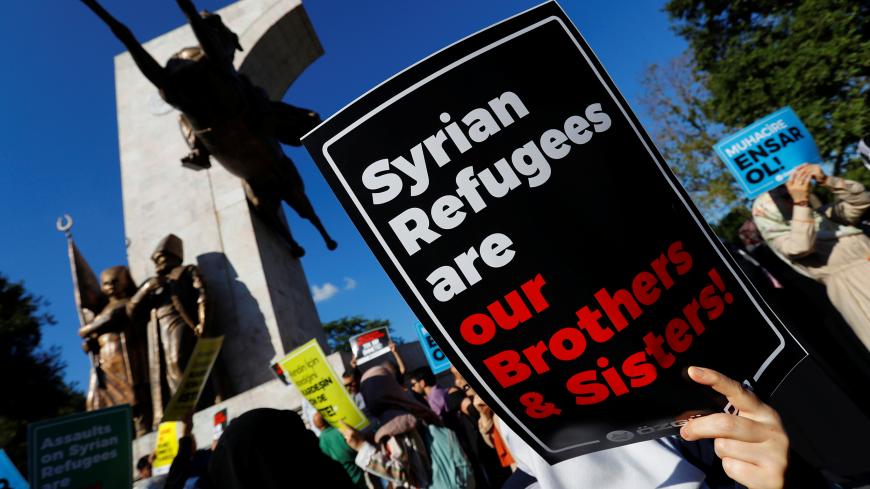 Demonstrators hold placards in support of Syrian refugees during a protest against Turkish government's recent refugee policies in Istanbul, Turkey, July 27, 2019. REUTERS/Murad Sezer - RC199EECAD00