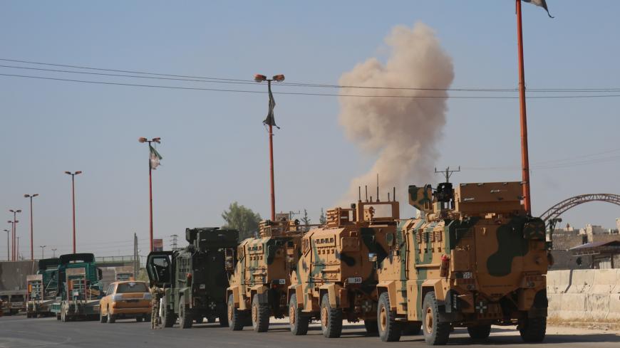 IDLIB, SYRIA - AUGUST 19: Turkish military convoy is seen on August 19, 2019 in Syria's northern province of Idlib. Syrian regime launches airstrikes on Maarat Al-Numan town as a convoy of Turkish military vehicles passes through the town. An airstrike killed three civilians and injured 12 others during a transfer to Turkeys observation point in Syrias Idlib. 
 (Photo by Izzettin Idilbi/Anadolu Agency via Getty Images)
