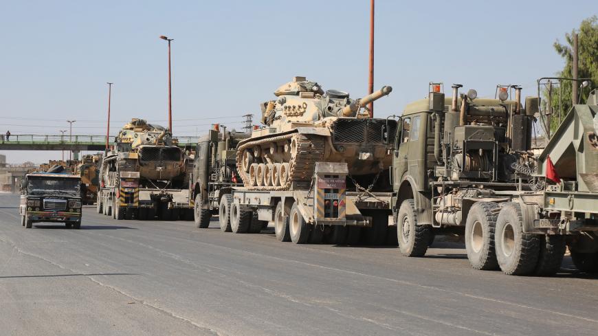 IDLIB, SYRIA - AUGUST 19: Turkish military convoy is seen on August 19, 2019 in Syria's northern province of Idlib. Syrian regime launches airstrikes on Maarat Al-Numan town as a convoy of Turkish military vehicles passes through the town. An airstrike killed three civilians and injured 12 others during a transfer to Turkeys observation point in Syrias Idlib.
(Photo by Izzettin Idilbi/Anadolu Agency via Getty Images)