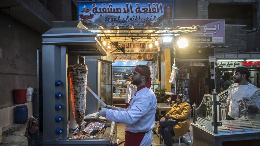 Syrian refugee Adel Bazmawi, 21, a co-founder and coach of the Syrian Sports Academy, works at a restaurant in Egypt's second city of Alexandria on January 4, 2018.
The academy is squeezed into just 30 square metres (320 square feet), in a modestly equipped hall at the bottom of a residential building in the Alexandria neighbourhood. The academy's founders began the project in 2016 with just 3,000 Egyptian pounds (about $430 at the time).
 / AFP PHOTO / KHALED DESOUKI        (Photo credit should read KHALED
