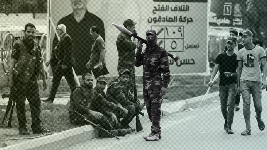 Iraqi fighters of the Hashed al-Shaabi units stand guard during a campaign gathering for the Fateh Alliance, a coalition of Iranian-supported militia groups, in Baghdad on May 7, 2018, ahead of Iraq's parliamentary elections to be held on May 12. (Photo by AHMAD AL-RUBAYE / AFP)        (Photo credit should read AHMAD AL-RUBAYE/AFP/Getty Images)
