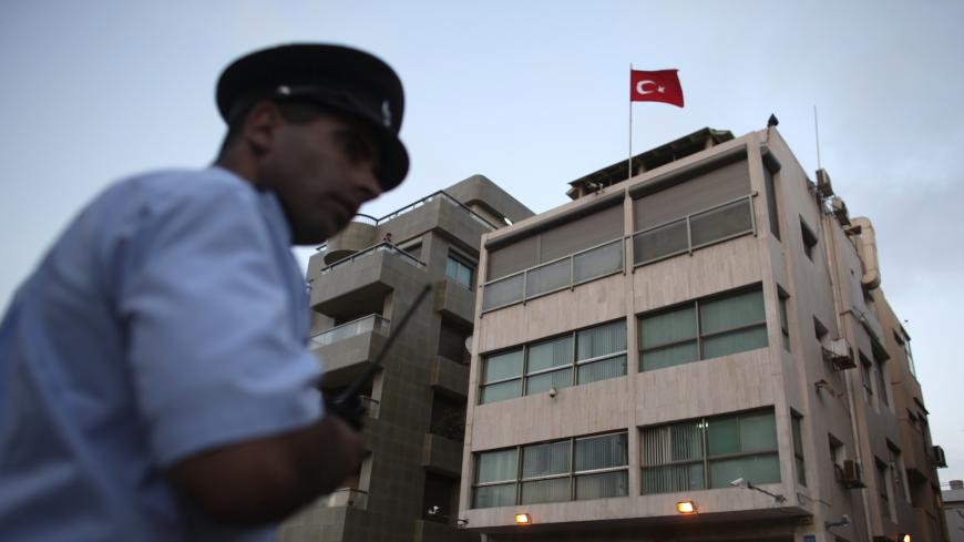 An Israeli police officer stands outside the Turkish embassy in Tel Aviv August 17, 2010. A Palestinian man known to Israeli police was shot and wounded by Turkish embassy security guards on Tuesday after breaking into the mission in Tel Aviv and holding hostages. REUTERS/Nir Elias (ISRAEL - Tags: POLITICS CIVIL UNREST) - GM1E68I0AH701