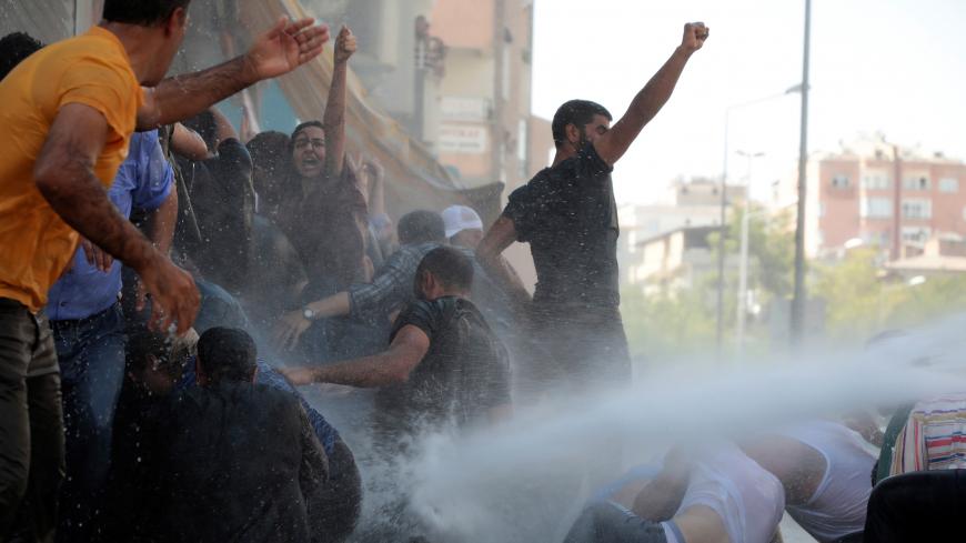 Police use a water cannon to disperse demonstrators during a protest against the replacement of Kurdish mayors with state officials in three cities, in Diyarbakir, Turkey, August 20, 2019. REUTERS/Sertac Kayar - RC13B9CF81F0