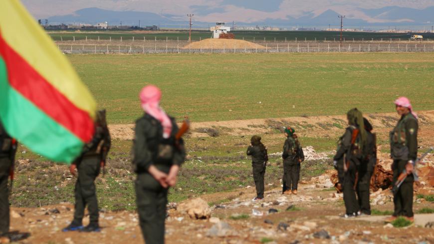 Kurdish members of the Self-Defense Forces stand near the Syrian-Turkish border in the Syrian city of al-Derbasiyah during a protest against the operations launched in Turkey by government security forces against the Kurds, February 9, 2016. REUTERS/Rodi Said - GF10000302386