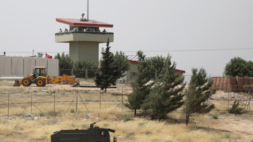 Turkish soldiers stand on a watch tower at the Atmeh crossing on the Syrian-Turkish border, as seen from the Syrian side, in Idlib governorate, Syria May 31, 2019. REUTERS/Khalil Ashawi - RC1525F30880