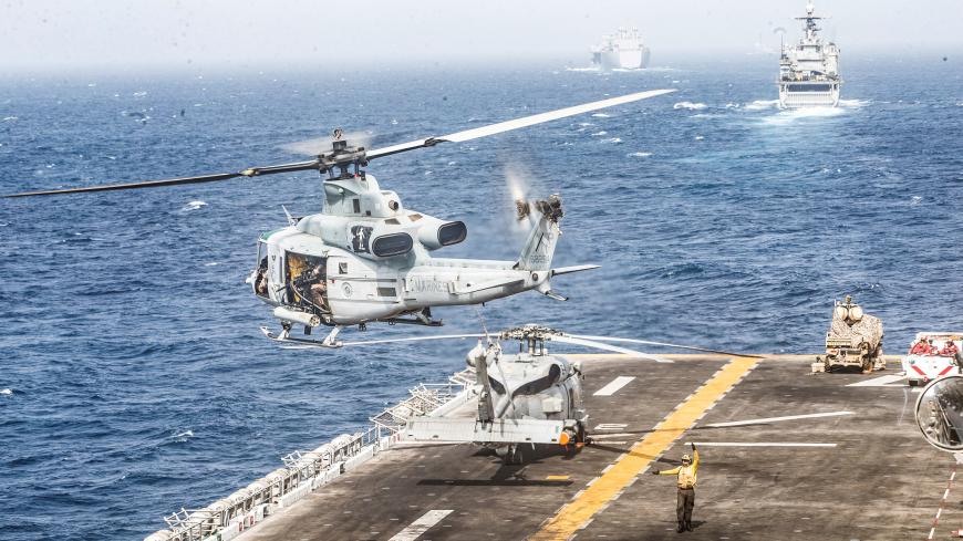 REFILE - REMOVING AND ADDING INFORMATION A U.S. Marines UH-1Y Venom helicopter takes off from the flight deck of the U.S. Navy amphibious assault ship USS Boxer, near a Light Marine Air Defense Integrated System (LMADIS) counter-unmanned aircraft system mounted on a vehicle parked at the bow, during its transit through Strait of Hormuz in Gulf of Oman, Arabian Sea, July 18, 2019. Picture taken July 18, 2019. Dalton Swanbeck/U.S. Navy/Handout via REUTERS ATTENTION EDITORS- THIS IMAGE HAS BEEN SUPPLIED BY A T