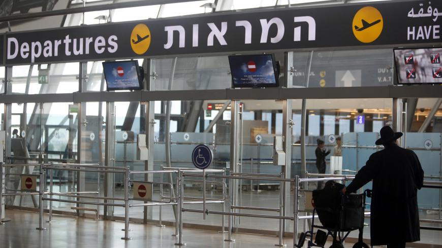 A passenger stands in the departure hall at Israel's Ben-Gurion International Airport near Tel Aviv, during a strike by airline workers, April 22, 2013. Israel's cabinet on Sunday approved an open skies agreement to boost airline traffic to and from Europe, defying a strike by workers at El Al and two smaller airlines who fear the greater competition with foreign airlines will cost them jobs. REUTERS/Nir Elias (ISRAEL - Tags: POLITICS TRANSPORT BUSINESS EMPLOYMENT CIVIL UNREST) - GM1E94M17SC01