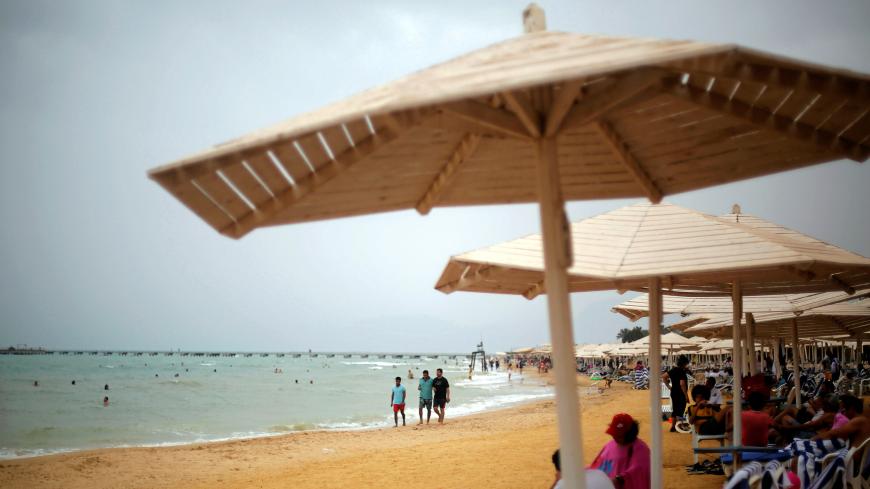 People enjoy on a beach at the Red Sea resort of El Ain El Sokhna in Suez, east of Cairo, Egypt May 7, 2018. REUTERS/Amr Abdallah Dalsh - RC111D7D6110