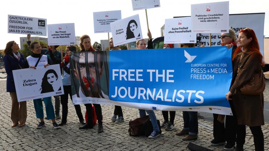 People hold placards prepared by Reporters Without Borders as they attend a demonstration organised for journalists detained in Turkey in front of the Berlin's main railway station, during the visit of Turkish President Tayyip Erdogan in Berlin, Germany, September 28, 2018. REUTERS/Christian Mang - RC1CDC76C5D0