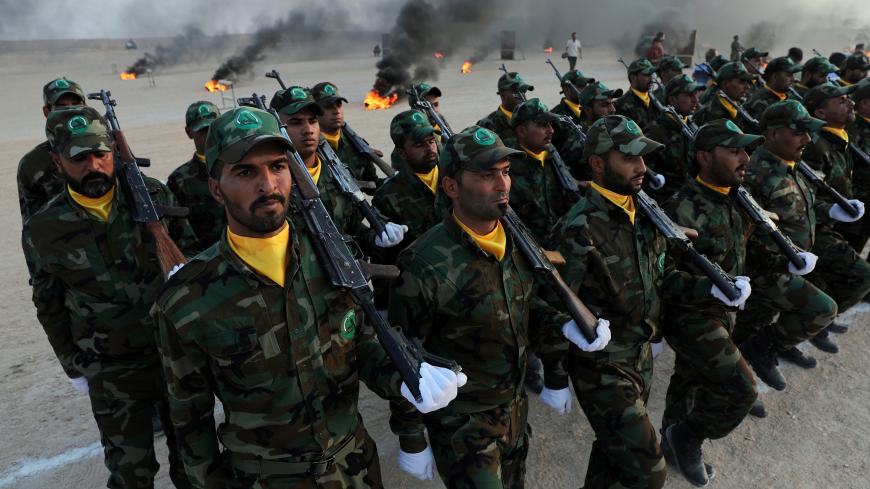 Members of the paramilitary Popular Mobilisation Forces (PMF) take part in their graduation ceremony at a military camp in Kerbala, Iraq August 30, 2019. REUTERS/Abdullah Dhiaa Al-Deen - RC1D99820E90