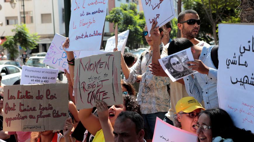 Moroccan activists hold signs in solidarity with Hajar Raissouni, a journalist charged with fornication and abortion, during a protest outside the Rabat tribunal, Morocco September 9, 2019. REUTERS/Youssef Boudlal - RC18C4FF30F0
