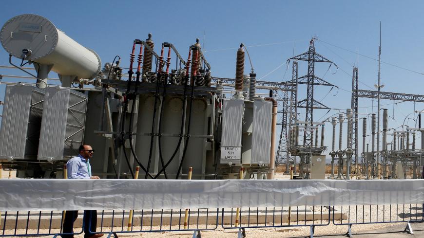 A worker walks in the new electrical substation near the West Bank city of Jenin July 10, 2017. REUTERS/Abed Omar Qusini - RC1E2622DFF0