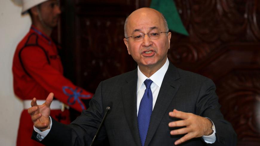 Iraq's President Barham Salih gestures during a news conference with Iranian President Hassan Rouhani (not pictured) at Salam Palace in Baghdad, Iraq March 11, 2019. REUTERS/Thaier al-Sudani - RC168FC63C00