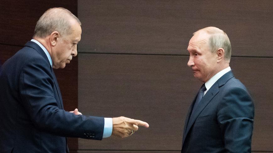 Russian President Vladimir Putin and Turkish President Tayyip Erdogan talk after a joint news conference with Iranian President Hassan Rouhani in Ankara, Turkey, September 16, 2019. Pavel Golovkin/Pool via REUTERS - RC18FEF72E00