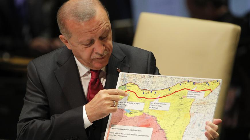 Turkey's President Recep Tayyip Erdogan holds up a map as he addresses the 74th session of the United Nations General Assembly at U.N. headquarters in New York City, New York, U.S., September 24, 2019. REUTERS/Brendan Mcdermid - HP1EF9O181E99