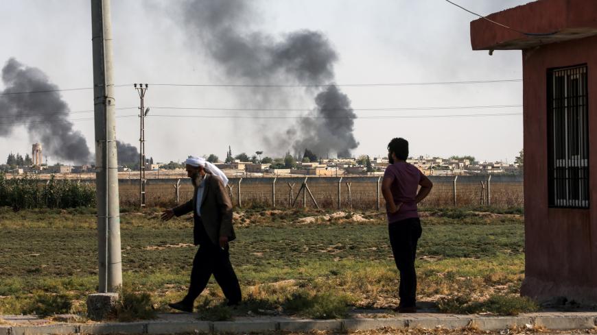 SANLIURFA, TURKEY - OCTOBER 10: A photo taken from Turkey's Sanliurfa province, on October 10, 2019 shows dark smoke rises at the site of Tell Abyad city of Syria after terrorists burnt tires to avoid being photographed by Turkish National Army's unmanned aerial vehicles (UAV) as Turkish troops along with the Syrian National Army begin Operation Peace Spring in northern Syria against PKK/YPG, Daesh terrorists. (Photo by Arif Hudaverdi Yaman/Anadolu Agency via Getty Images)