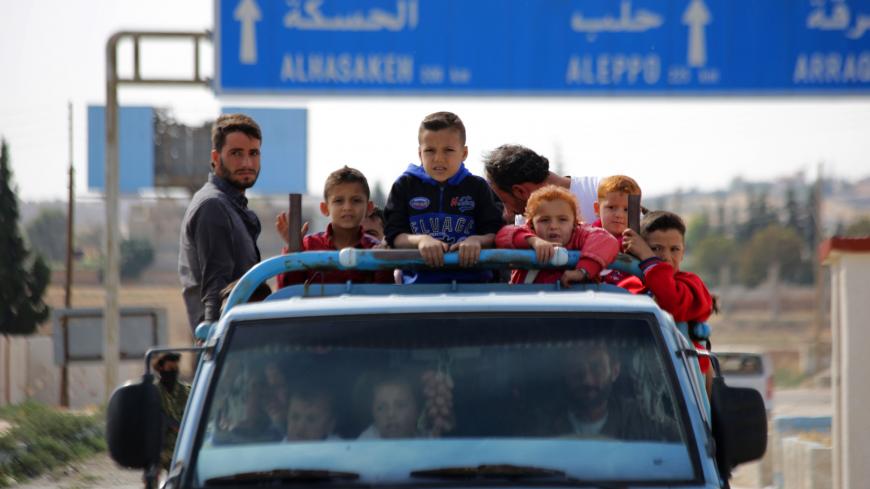 Syrians return to their homes in the town of Ayn al-Arus, south of the border town of Tal Abyad, on October 14, 2019, after it was taken over by Turkish-backed Syrian fighters during their assault on Kurdish-held border towns in northeastern Syria. - Syrian regime forces moved towards the Turkish border after Damascus reached a deal with beleaguered Kurdish forces following a US withdrawal announcement, AFP correspondents reported. (Photo by Bakr ALKASEM / AFP) (Photo by BAKR ALKASEM/AFP via Getty Images)